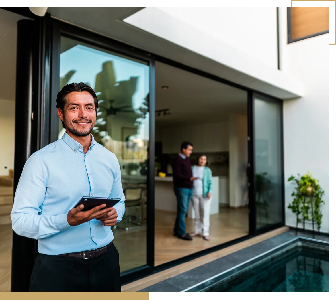Happy man standing outside luxury house